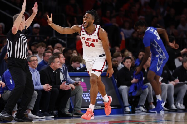 St. John's forward Zuby Ejiofor (24) reacts after making a 3-point shot against Creighton during the first half of an NCAA college basketball game, Sunday, Feb. 16, 2025, in New York. (AP Photo/Noah K. Murray)