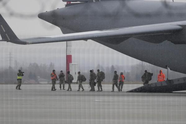 U.S. Army troops of the 82nd Airborne Division unloading vehicles from a transport plane after arriving from Fort Bragg, at the Rzeszow-Jasionka airport in southeastern Poland, Sunday, Feb. 6, 2022. Additional U.S. troops are arriving in Poland after President Joe Biden ordered the deployment of 1,700 soldiers here amid fears of a Russian invasion of Ukraine. Some 4,000 U.S. troops have been stationed in Poland since 2017. (AP Photo/Czarek Sokolowski)