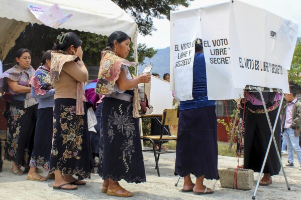 Indigenous women line up to vote during general elections in Zinacantan, Mexico, Sunday, June 2, 2024. (AP Photo/Luis Etzin)