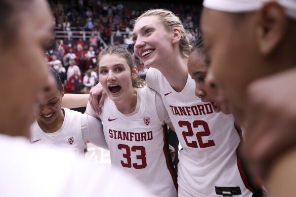 Stanford seniors Cameron Brink (22) and Hannah Jump huddle with teammates after Cardinal's 81-67 win over Arizona State during a NCAA Pac 12 women's basketball game at Maples Pavilion in Stanford, Calif., on Sunday, Feb. 25, 2024. (Scott Strazzante/San Francisco Chronicle via AP)