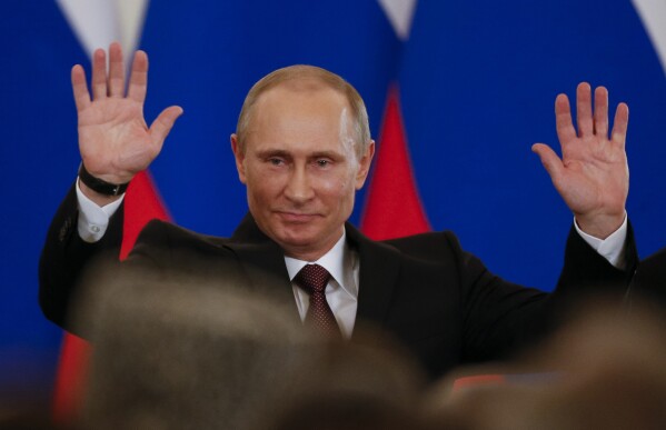 FILE - Russian President Vladimir Putin gestures after signing a treaty incorporating Crimea as part of Russia in the Kremlin in Moscow, Russia, on Tuesday, March 18, 2014. Putin’s quick and bloodless seizure of Ukraine's Crimean Peninsula, home to Russia's Black Sea fleet and a popular vacation site, touched off a wave of patriotism and sent his popularity soaring. "Crimea is ours!" became a popular slogan in Russia. (AP Photo/Alexander Zemlianichenko, File)