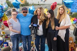 FILE - In this Tuesday, May 25, 2021, file photo, family members of 6-year-old Aiden Leos stand at a makeshift memorial on the Walnut Avenue overpass at the 55 Freeway in Orange, Calif., to announce that the reward for information leading to the suspects in the road-rage shooting death of Leos. Family members and friends tearfully remembered Leos, who was shot and killed in the incident on a Southern California freeway, at his memorial service on Saturday, June 5. (Leonard Ortiz/The Orange County Register via AP, File)