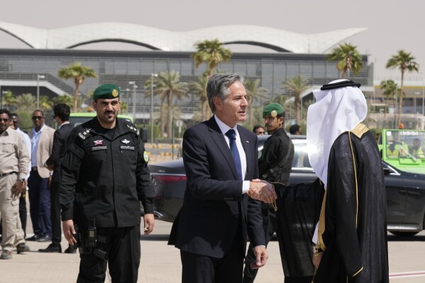 U.S. Secretary of State Antony Blinken shakes hands with a Saudi official before boarding a plane to leave Riyadh, Saudi Arabia, Sunday, Oct. 15, 2023. (AP Photo/Jacquelyn Martin, Pool)