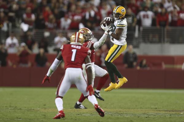 Green Bay Packers wide receiver Davante Adams, right, catches a pass against San Francisco 49ers middle linebacker Fred Warner, rear, and cornerback Jimmie Ward (1) during the second half of an NFL football game in Santa Clara, Calif., Sunday, Sept. 26, 2021. (AP Photo/Jed Jacobsohn)