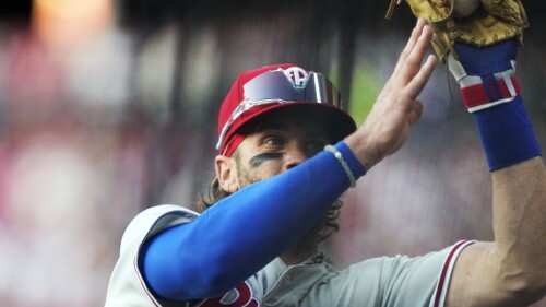 Philadelphia Phillies first baseman Bryce Harper catches a foul ball hit by Cleveland Guardians' Amed Rosario for an out in the third inning of a baseball game Friday, July 21, 2023, in Cleveland. (AP Photo/Sue Ogrocki)