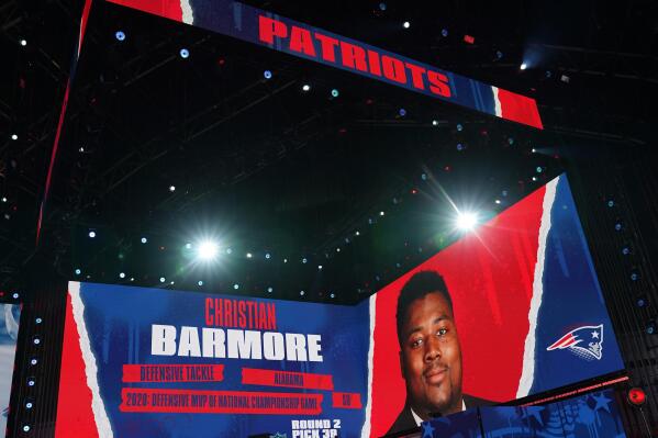 Images are displayed on stage of Christian Barmore, defensive tackle at Alabama, selected by the New England Patriots in the second round of the NFL football draft, Friday, April 30, 2021, in Cleveland. (AP Photo/Tony Dejak)