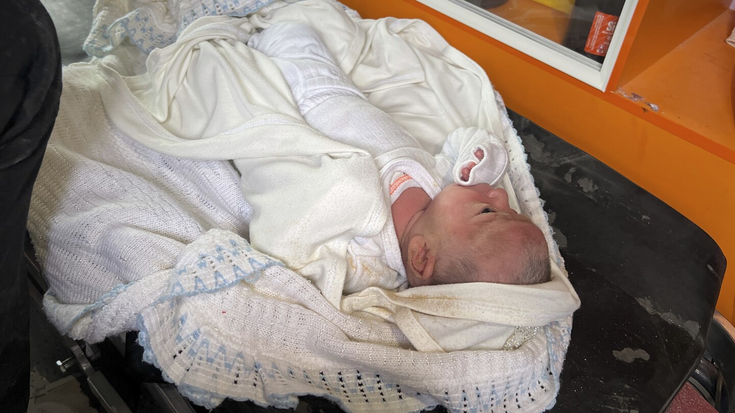 A month-old girl is pulled from the rubble in Gaza after an airstrike killed her parents
