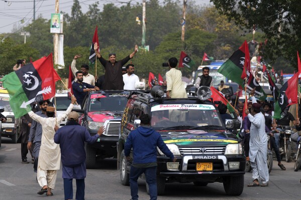 Supporters of Pakistan People's Party travel on vehicles as they wave party flags and flashing victory signs during an election campaign rally, in Karachi, Pakistan, Monday, Feb. 5, 2024. The elections are the twelfth in the country's 76-year history, which has been marred by economic crises, military takeovers and martial law, militancy, political upheavals and wars with India. (AP Photo/Fareed Khan)