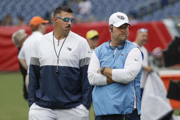 FILE - Tennessee Titans head coach Mike Vrabel, left, and general manager Jon Robinson walk on the field before a practice in Nissan Stadium during NFL football training camp Saturday, Aug. 3, 2019, in Nashville, Tenn. The Tennessee Titans have extended the contracts of general manager Jon Robinson and coach Mike Vrabel to keep them around for years to come, Tuesday, Feb. 8, 2022. (AP Photo/Mark Humphrey, File)