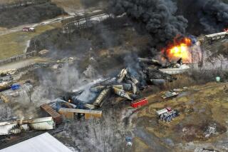 FILE - This photo taken with a drone on Feb. 4, 2023, shows portions of a Norfolk Southern freight train still on fire that derailed on Feb. 3, in East Palestine, Ohio. Norfolk Southern has agreed to exclusively use Ohio-based businesses to clean up the site of the fiery train derailment in a small town near the Pennsylvania state line. Ohio Attorney General Dave Yost made the announcement Wednesday, March 29. (AP Photo/Gene J. Puskar, File)