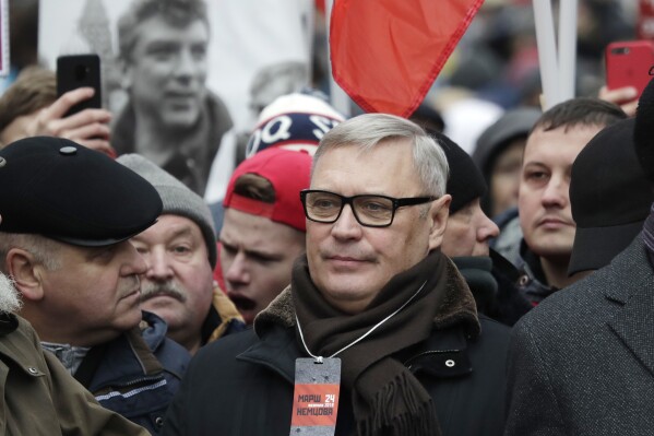 FILE - Former Russian Prime Minister, and one of opposition leaders, Mikhail Kasyanov, center, attends a march in memory of opposition leader Boris Nemtsov in Moscow, Russia, on Feb. 24, 2019. Russia's Justice Ministry on Friday, Nov. 24, 2023, added Mikhail Kasyanov, who was President Vladimir Putin's first prime minister but then became one of his opponents, to its register of “foreign agents.”Russian law allows for figures and organizations receiving money or support from outside the country to be designated as foreign agents, a term whose pejorative connotations could undermine the designee's credibility. (AP Photo/Pavel Golovkin)
