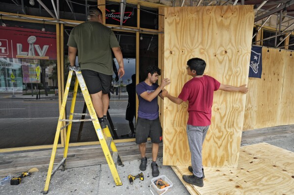 Workers at Toucans Bar and Grill board up the restaurant windows ahead of Hurricane Idalia near Clearwater Beach Tuesday, Aug. 29, 2023, in Clearwater, Fla. Residents along Florida's gulf coast are making preparations for the effects of Idalia. (AP Photo/Chris O'Meara)