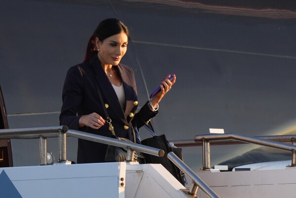 Laura Loomer arrives with Republican presidential nominee former President Donald Trump at Philadelphia International Airport, Sept. 10, 2024, in Philadelphia. (AP Photo/Chris Szagola, File)