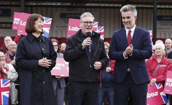 Britain's Labour Party leader Sir Keir Starmer, center, and shadow chancellor Rachel Reeves, celebrate with David Skaith at Northallerton Town Football Club, North Yorkshire, after winning the York and North Yorkshire mayoral election, Friday May 3, 2024. (Owen Humphreys/PA via Ǻ)