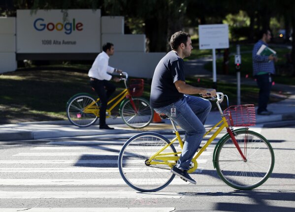 
              FILE - In this Oct. 20, 2015 file photo, employees ride company bicycles outside Google headquarters in Mountain View, Calif. Hundreds of Google employees are expected to temporality leave their jobs Thursday morning Nov. 1, 2018, in a mass walkout protesting the internet company's lenient treatment of executives accused of sexual misconduct. (AP Photo/Marcio Jose Sanchez, File)
            