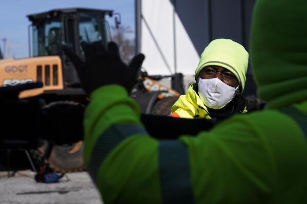 A Georgia Department of Transportation response member looks at a brine truck tank being filled ahead of a winter storm at the GDOT's Maintenance Activities Unit location on Friday, Jan. 14, 2022, in Forest Park, Ga. A winter storm is headed south that could effect much of Georgia through Sunday. (AP Photo/Brynn Anderson)