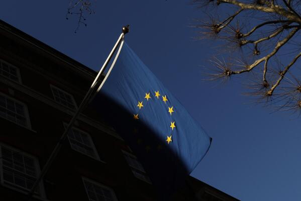 FILE - In this file photo dated Friday Jan. 22, 2021, the European Union flag flies outside Europe House in London.  Privacy campaign groups Thursday May 27, 2021, have filed a slew of legal complaints with European regulators against Clearview AI, alleging the facial recognition technology it provides to law enforcement agencies and businesses has stockpiled biometric data on more than 3 billion people without their knowledge or permission by “scraping" images from websites, breaching stringent EU privacy rules. (AP Photo/Alastair Grant, FILE)