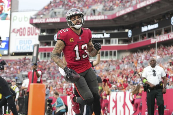 FILE - Tampa Bay Buccaneers wide receiver Mike Evans (13) looks toward the stands after his first touchdown of the first half during an NFL football game against the Jacksonville Jaguars, Sunday, Dec. 24, 2023, in Tampa, Fla. Tampa Bay receiver Mike Evans has agreed to a two-year, $52 million contract to remain with the Tampa Bay Buccaneers instead of testing his worth in free agency, a person familiar with the deal told The Associated Press. The person spoke to the AP on condition of anonymity Monday, March 4, 2024, because the contract had not been finalized. (AP Photo/Peter Joneleit, File)