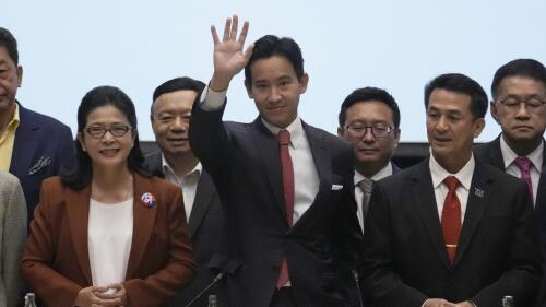 Move Forward Party leader Pita Limjaroenrat, center, waves during a news conference with other party leaders, in Bangkok, Thailand, Thursday, May 18, 2023. Thailand's election winner Move Forward Party announced on Thursday a coalition of eight parties that its leader declared will become one 