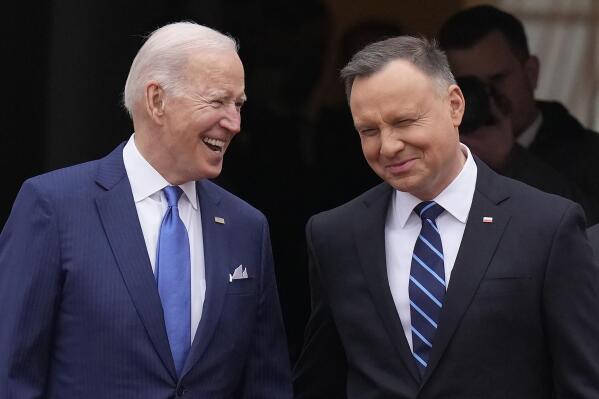 U.S. President Joe Biden, left, and Polish President Andrzej Duda smile during a military welcome ceremony at the Presidential Palace in Warsaw, Poland, on Saturday, March 26, 2022. (AP Photo/Czarek Sokolowski)