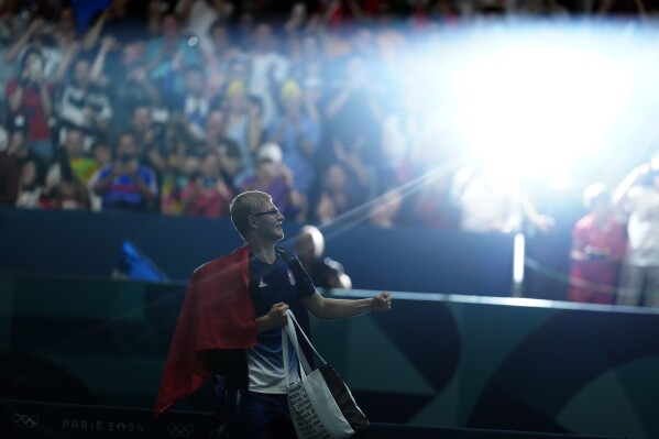 France's Felix Lebrun celebrates after defeating Barzil's Hugo Calderano in the men's singles bronze medal table tennis match at the 2024 Summer Olympics, Sunday, Aug. 4, 2024, in Paris, France. (AP Photo/Petros Giannakouris)