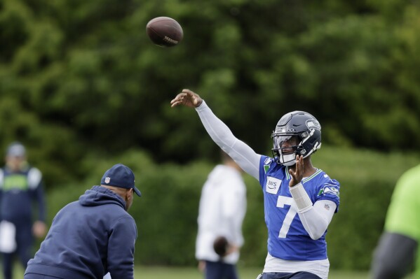 Seattle Seahawks quarterback Geno Smith throws a pass during an NFL football practice, Wednesday, May 22, 2024, in Renton, Wash. (AP Photo/ John Froschauer)