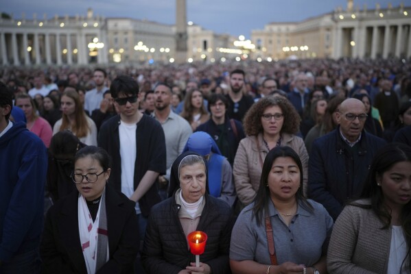 Faithful gather for a rosary prayer for the late Pope Francis, in St. Peter's Square at the Vatican, Monday April 21, 2025 (AP Photo/Alessandra Tarantino)