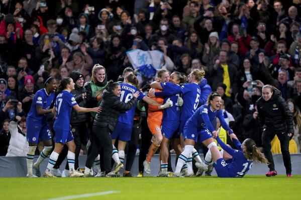 Chelsea players celebrate after winning the penalty shootout after the Women's Champions League quarterfinal second leg match against Olympique Lyon at Stamford Bridge, London, Thursday March 30, 2023. (Adam Davy/PA via AP)