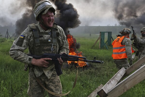 In this photo provided by Ukraine's 65th Mechanized Brigade press service, Ukrainian servicemen attend a military training in Zaporizhzhia region, Ukraine, Monday, May 26, 2025. (Andriy Andriyenko/Ukraine's 65th Mechanized Brigade via AP)