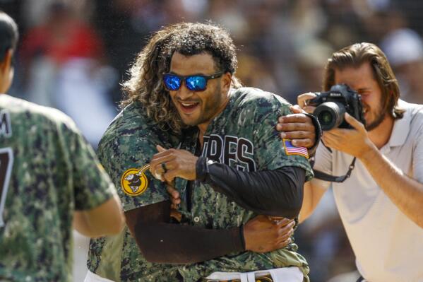 From left to right, San Diego Padres' Jorge Alfaro celebrates with Trent Grisham after hitting a two-run walk off home run, defeating the Pittsburgh Pirates 4-2 in the 10th inning of a baseball game, Sunday, May 29, 2022, in San Diego. (AP Photo/Mike McGinnis)