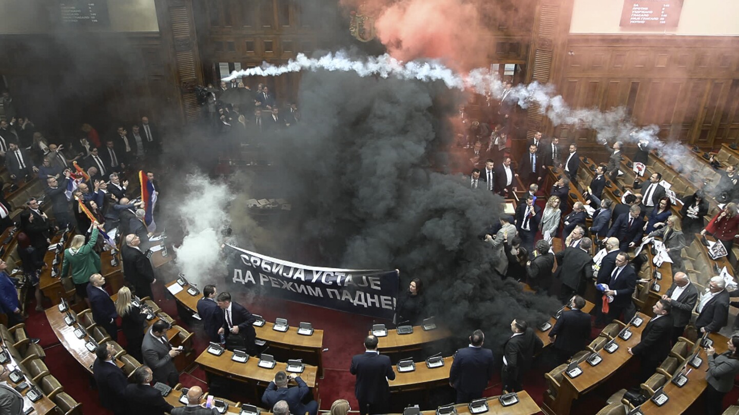 At least 3 Serbian lawmakers injured as smoke bombs and flares thrown in parliament