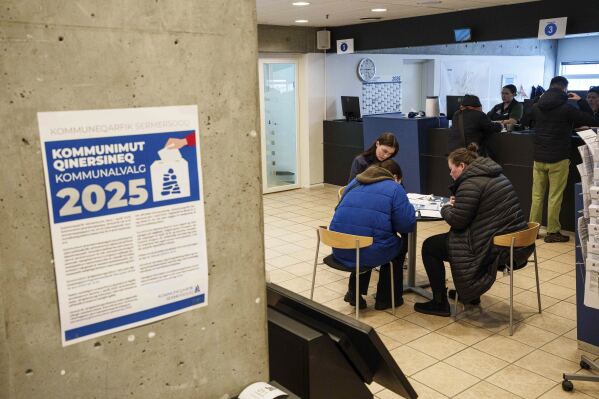 People vote during an early voting for Greenlandic parliamentary elections at the city hall in Nuuk, Greenland, Monday, March 10, 2025. (AP Photo/Evgeniy Maloletka)
