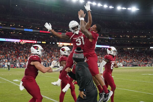 Arizona Cardinals running back Emari Demercado (31) celebrates with quarterback Kyler Murray, foreground, and teammates after scoring on a two point conversion during the second half of an NFL preseason football game against the Denver Broncos in Glendale, Ariz., Friday, Aug. 11, 2023. (AP Photo/Matt York)