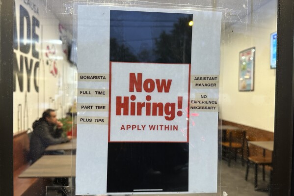 A hiring sign is displayed at a restaurant in Rolling Meadows, Ill., Tuesday, Oct. 10, 2023. On Thursday, the Labor Department reports on the number of people who applied for unemployment benefits last week. (AP Photo/Nam Y. Huh)