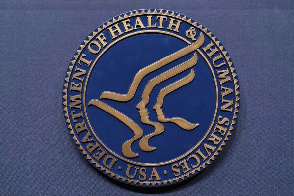The Health and Human Services seal is seen before a news conference with Secretary Robert F. Kennedy Jr. in Washington, April 16, 2025. (AP Photo/Jose Luis Magana, File)