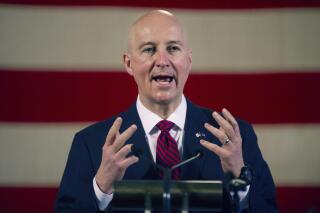 FILE - In this Feb. 26, 2021, file photo, Nebraska Gov. Pete Ricketts speaks during a news conference at the Nebraska State Capitol in Lincoln, Neb. Gov. Ricketts is resurrecting a version of Nebraska's daily virus reporting dashboard website because the number of COVID-19 hospitalizations has continued to rise through the summer. (Kenneth Ferriera/Lincoln Journal Star via AP File)