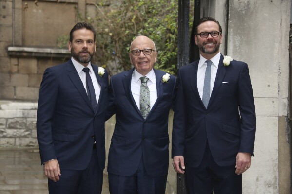 FILE - From left, Lachlan Murdoch, Rupert Murdoch and James Murdoch arrive at St Bride's Church for the celebration ceremony of the wedding of Rupert Murdoch and Jerry Hall in London, Saturday, March 5, 2016. (Photo by Joel Ryan/Invision/AP, File)