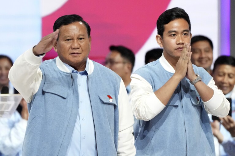 FILE - Presidential candidate Prabowo Subianto, left, and his running mate Gibran Rakabuming Raka, the eldest son of Indonesian President Joko Widodo, arrive for the fifth presidential candidates' debate in Jakarta, Indonesia, Sunday, Feb. 4, 2024.  Indonesia, the world's third-largest democracy, will cast about 205 million eligible voters on Wednesday in presidential and legislative elections, the fifth by Southeast Asia's largest economy since it began democratic reforms in 1998.  (AP Photo/Taton Ciufflana, File)