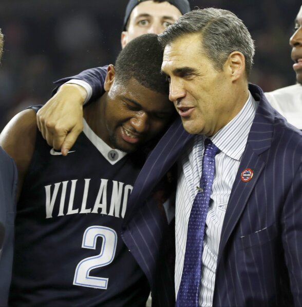 FILE - In this April 4, 2016, file photo, Villanova head coach Jay Wright, right, embraces Kris Jenkins after Jenkins scored the game-winning three-point basket in the closing seconds of the NCAA Final Four college basketball championship game against North Carolina, in Houston.  (AP Photo/David J. Phillip, File)