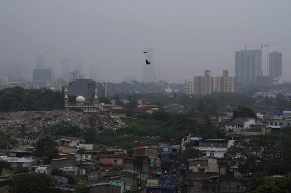 Smog and fog envelop the skyline in Colombo, Sri Lanka, Friday, Dec. 9, 2022. Schools across Sri Lanka were closed on Friday as health and environment officials said air quality was unhealthy in most parts of the island nation partly due to extreme weather conditions. (AP Photo/Eranga Jayawardena)