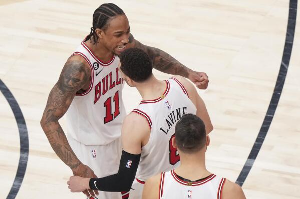 Chicago Bulls forward DeMar DeRozan (11) celebrates with Zach LaVine (8) and Nikola Vucevic after the team's win over the Toronto Raptors in an NBA basketball play-in tournament game Wednesday, April 12, 2023, in Toronto. (Nathan Denette/The Canadian Press via AP)