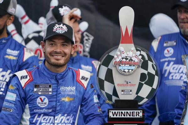 Kyle Larson smiles with his trophy after winning a NASCAR Cup Series auto race in Watkins Glen, N.Y., Sunday, Aug. 21, 2022. (AP Photo/Seth Wenig)