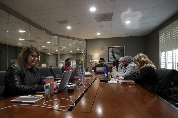 The Bay Church online pastoral team work on their computers during an online church service in Concord, Calif., Sunday, March 15, 2020. (AP Photo/Jeff Chiu)