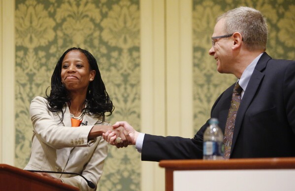 Republican Mia Love and Democrat Doug Owens shake hands after a debate in Salt Lake City, May 20, 2014. (Jeffrey D. Allred/The Deseret News via AP, File)