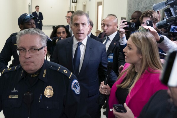 Hunter Biden, President Joe Biden's son, center, leaves a House Oversight Committee hearing as Republicans are taking the first step toward holding him in contempt of Congress, Wednesday, Jan. 10, 2024, on Capitol Hill in Washington. (AP Photo/Jose Luis Magana)