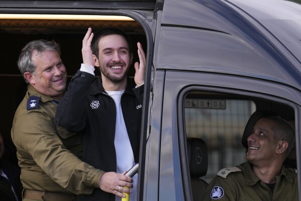 Freed Israeli hostage Omer Shem Tov looks on from a van as he arrives at Beilinson hospital in Petah Tikva, Israel, after he was released from Hamas captivity in the Gaza Strip, Feb. 22, 2025. (AP Photo/Ariel Schalit, File)
