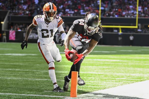 Atlanta Falcons running back Cordarrelle Patterson (84) runs in a touchdown against Cleveland Browns cornerback Denzel Ward (21) during the first half of an NFL football game, Sunday, Oct. 2, 2022, in Atlanta. (AP Photo/John Amis)