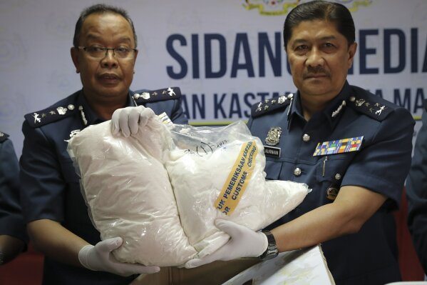 This June 26, 2019, photo shows customs officials display seized drugs at the customs office in Sepang. Malaysia's government has announced plans to remove criminal penalties for the possession and use of drugs in small quantity to battle addiction, but stressed the move is not akin to legalizing drugs. (AP Photo/Vincent Thian)
