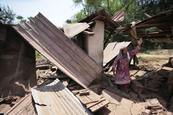 Parmer Akhtar inspects her house which was damaged by Pakistani artillery shelling on the outskirts of Jammu, India, Saturday, May 10, 2025. (AP Photo/Channi Anand)