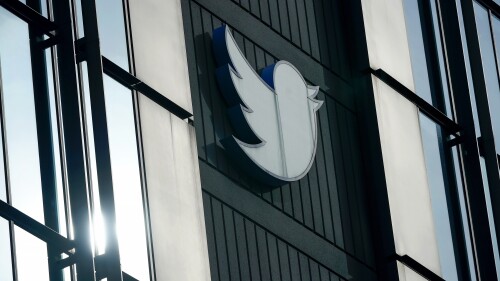 FILE - A Twitter logo hangs outside the company's offices in San Francisco, Dec. 19, 2022. Current and former employees filed a lawsuit against Twitter on Tuesday, June 20, 2023, over bonuses they say the social media company failed to pay despite promises it would. (AP Photo/Jeff Chiu, File)